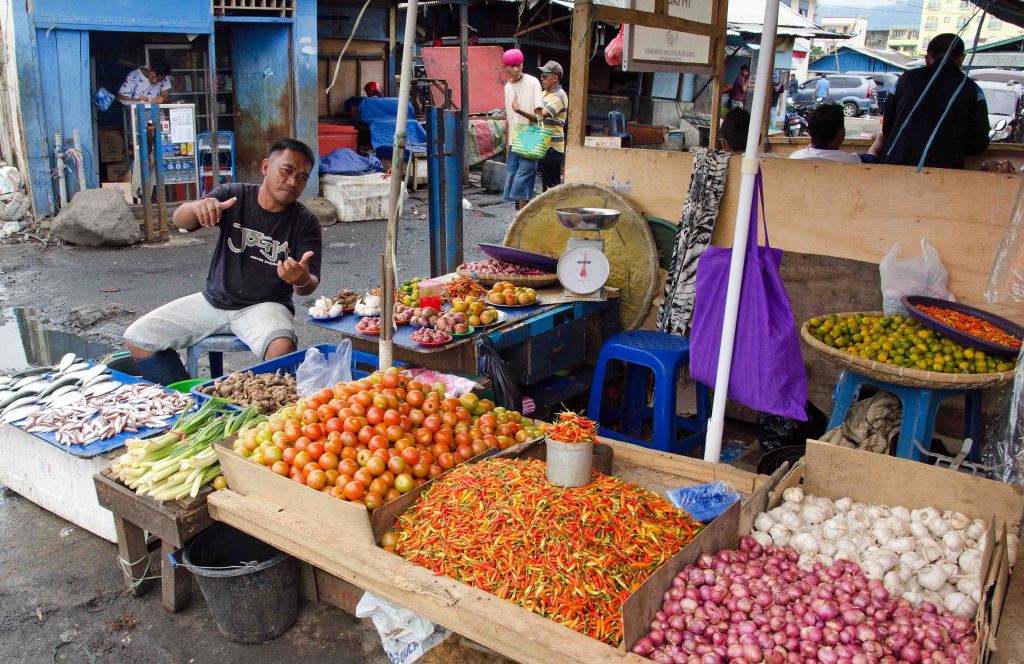 Stall keeper giving me the thumbs up for taking a picture of his market stall in Madado, Sulawesi.