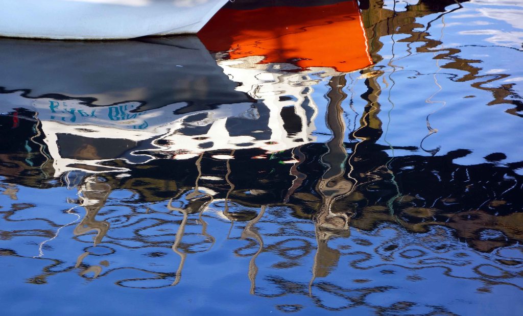 Reflection of boat in harbour 