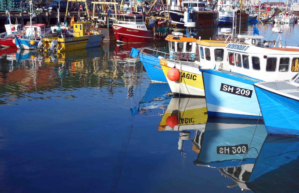 Colourful fishing boats produce attractive reflections