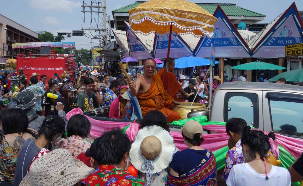 Buddhist monks blessing people with water