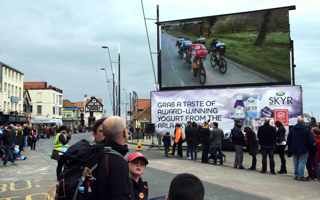 Giant monitor screen showing the race live