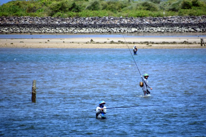 Fisherman in the sea outside Benoa Port, Bali